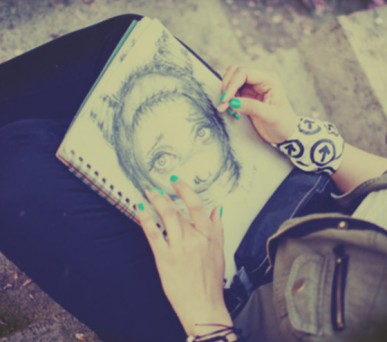 close up of a girl sketching.